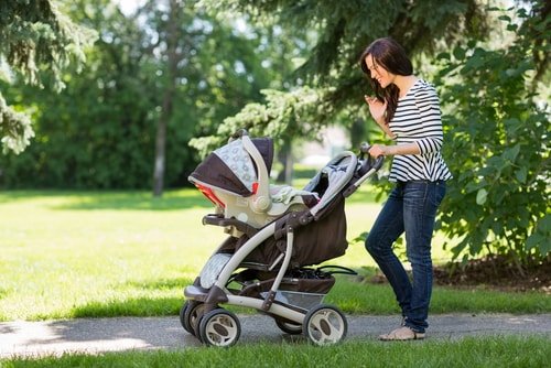 woman walking with stroller woman walking with stroller