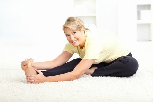 older woman smiling during yoga older woman smiling during yoga