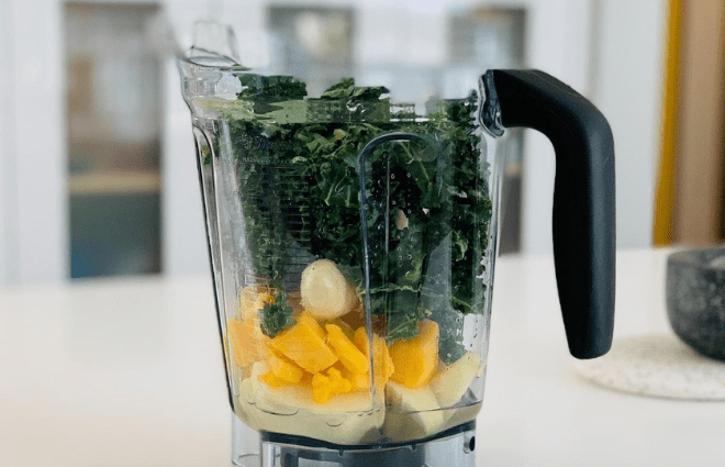 Blender pitcher with smoothie bowl ingredients